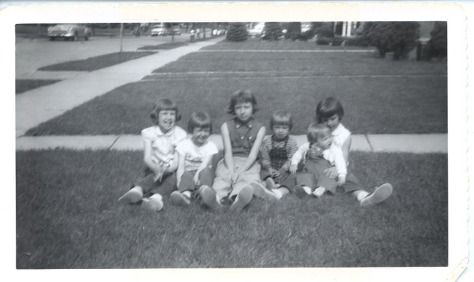 Second to youngest, with my sisters on the lawn in Roseville, MI, later 1950s.